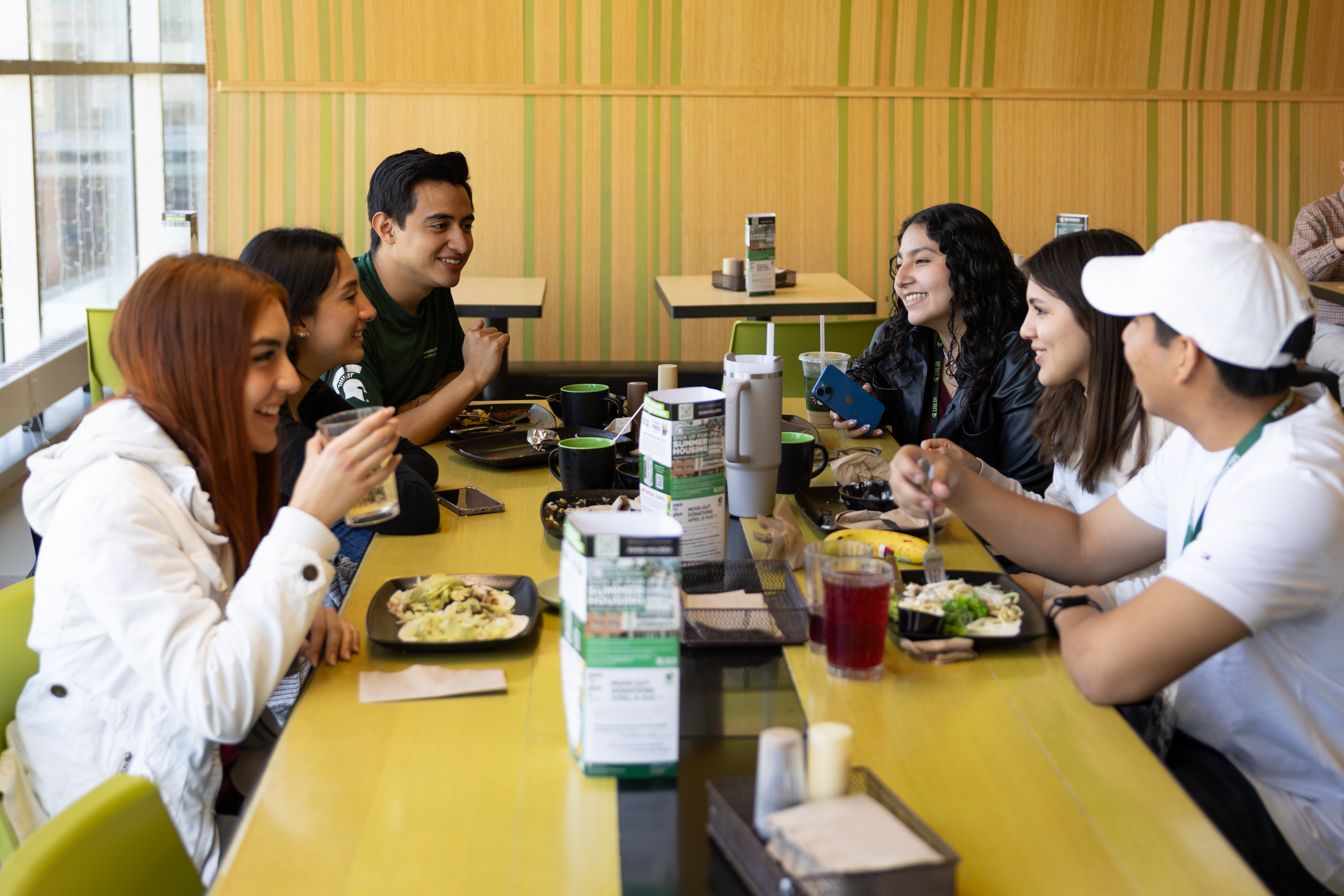 Students gather to eat and spend time together in a dining hall