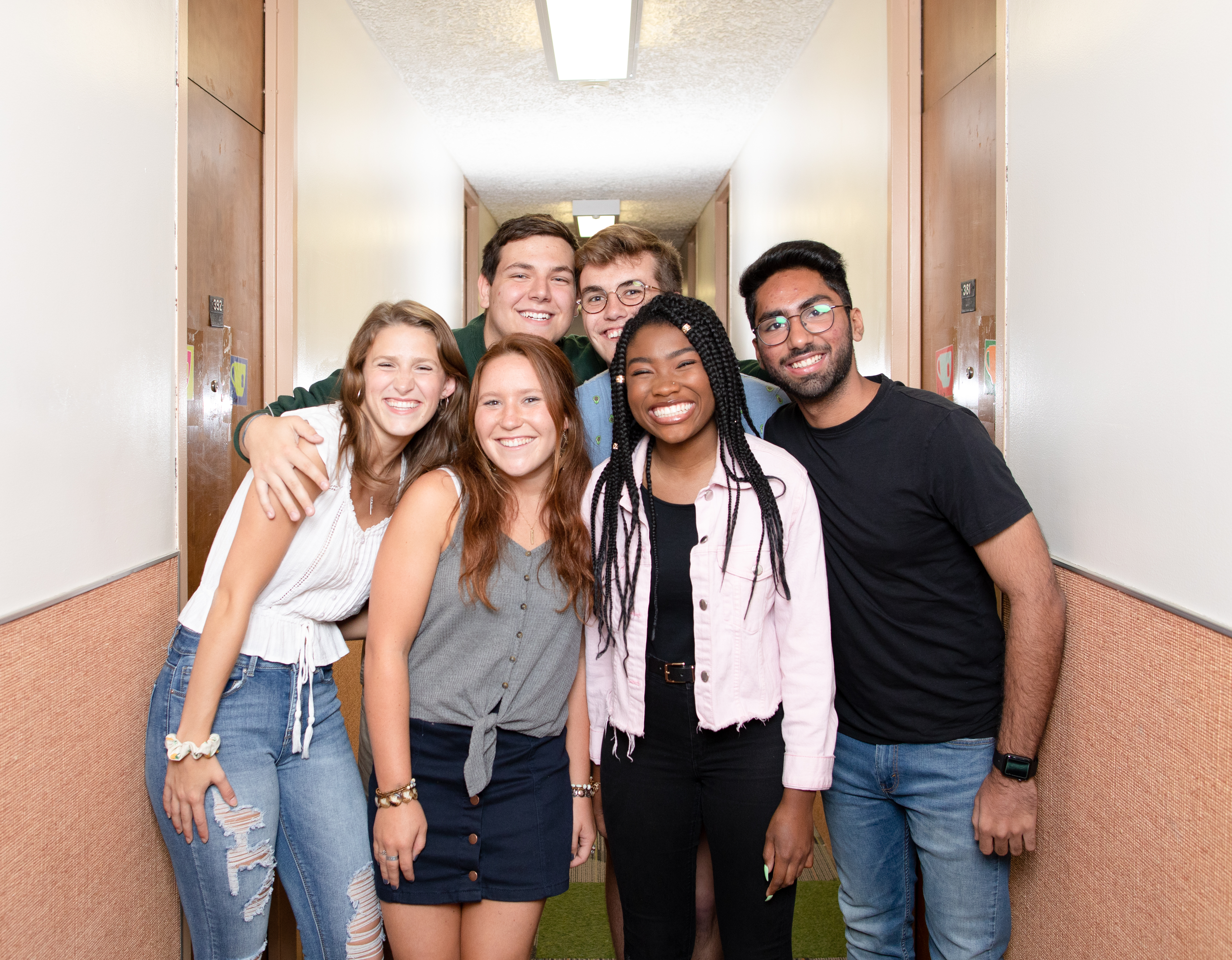 students gathered in the hallway of a residence wing