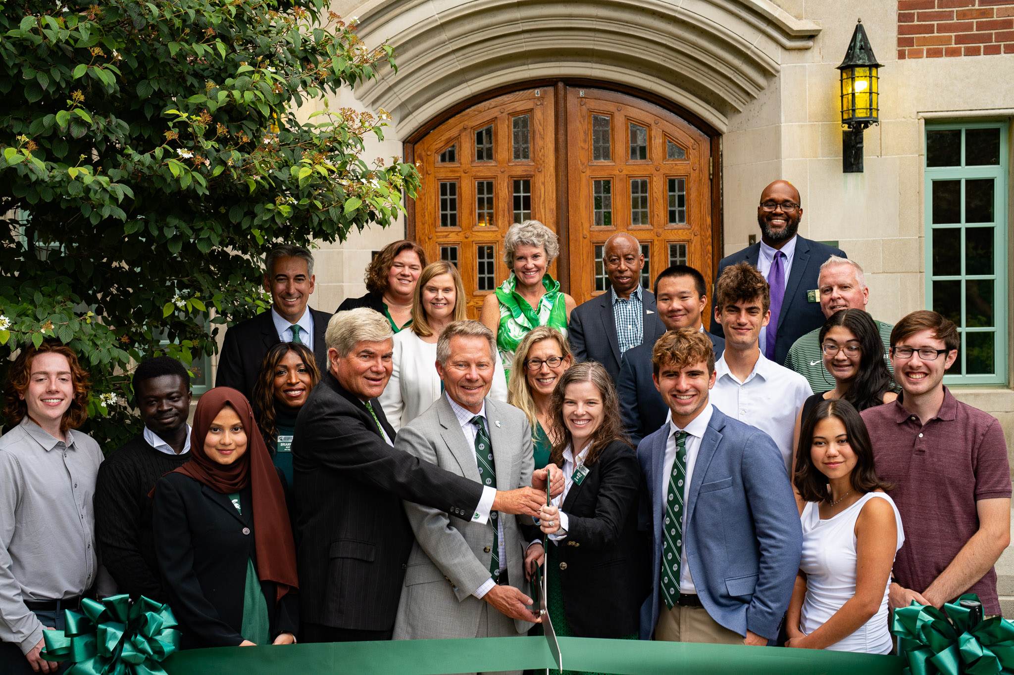 Michigan State University leaders, students, and staff gather outside Campbell Hall for a ribbon-cutting ceremony celebrating the building’s reopening.