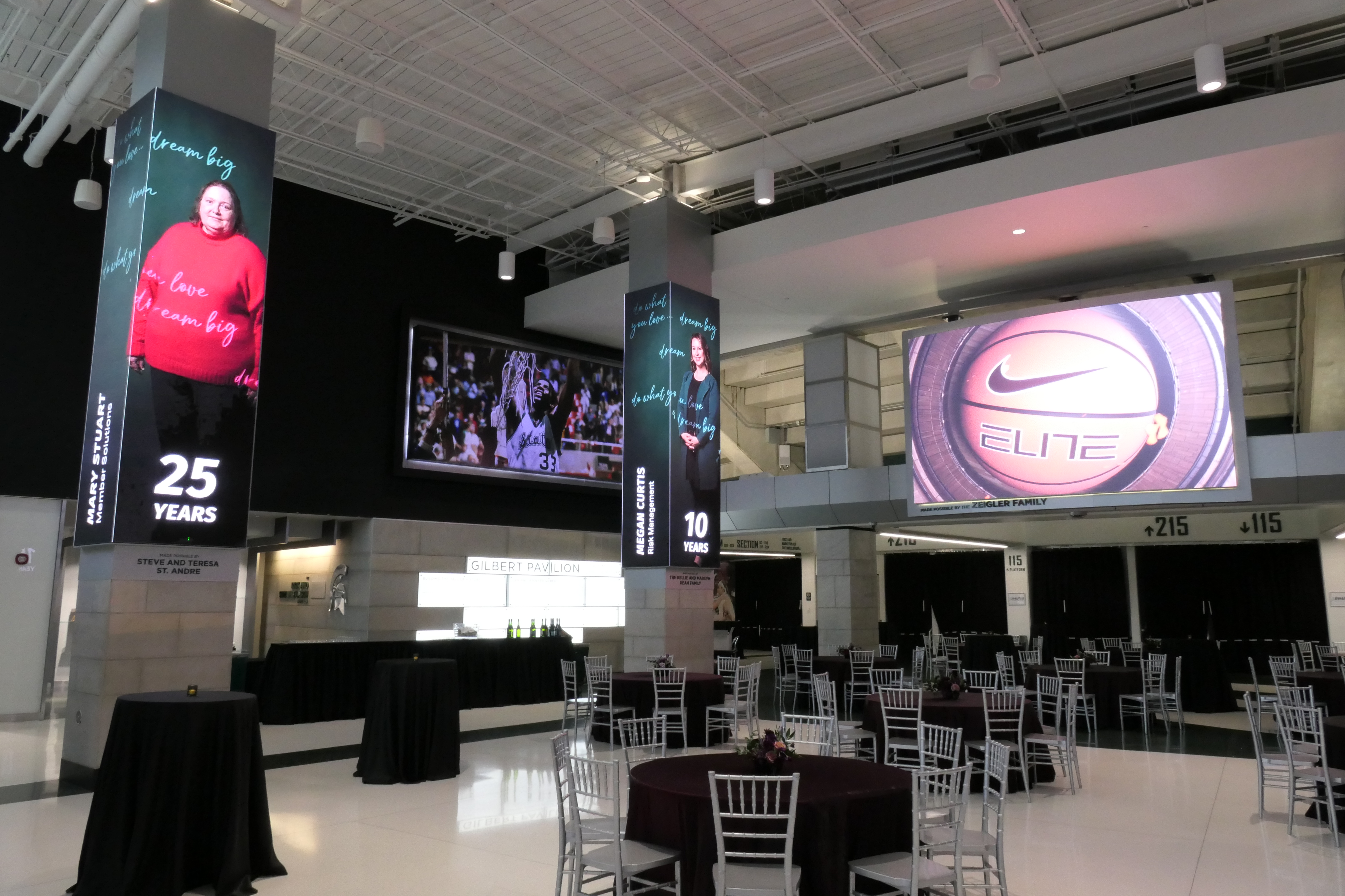 A view of the Breslin Center concourse with tables decorated with linens and flowers prior to the recent MSUFCU Banquet.