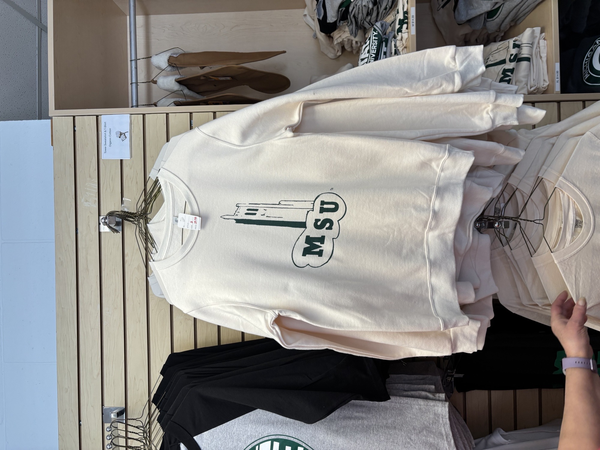 A crème crew neck with a unique Beaumont Tower design for $29.99, as well as a T-shirt with the same design for $14.99 at Spartan Linen Services.