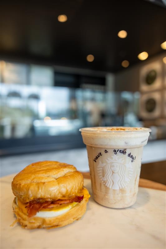 A Starbucks Combo on campus, featuring a cold drink and breakfast sandwich.
