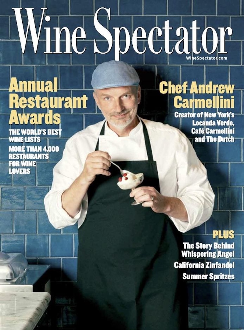 Cover of Wine Spectator’s annual restaurant awards issue featuring a chef in apron eating a dessert.