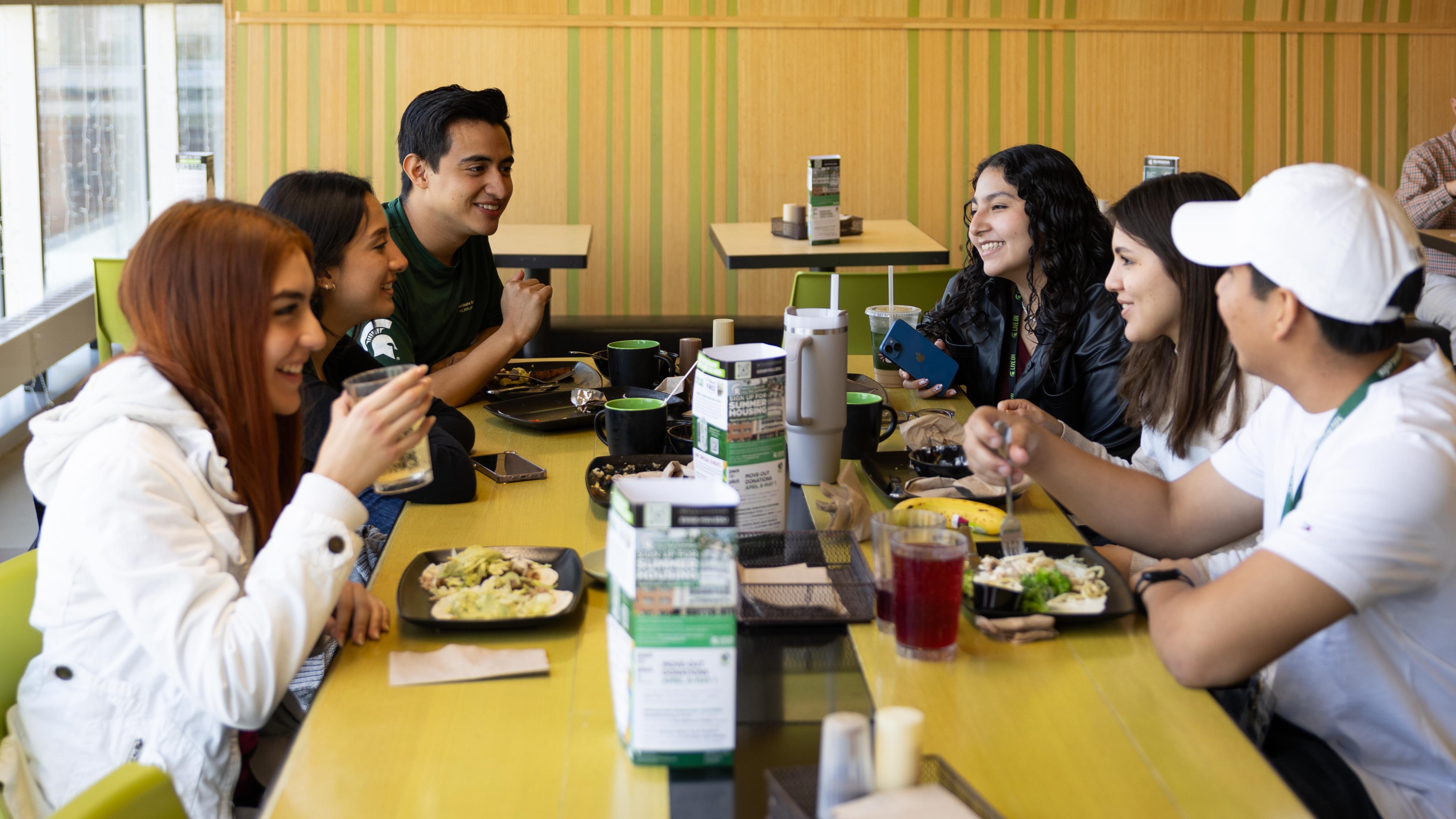 students gather to eat and spend time together in a dining hall