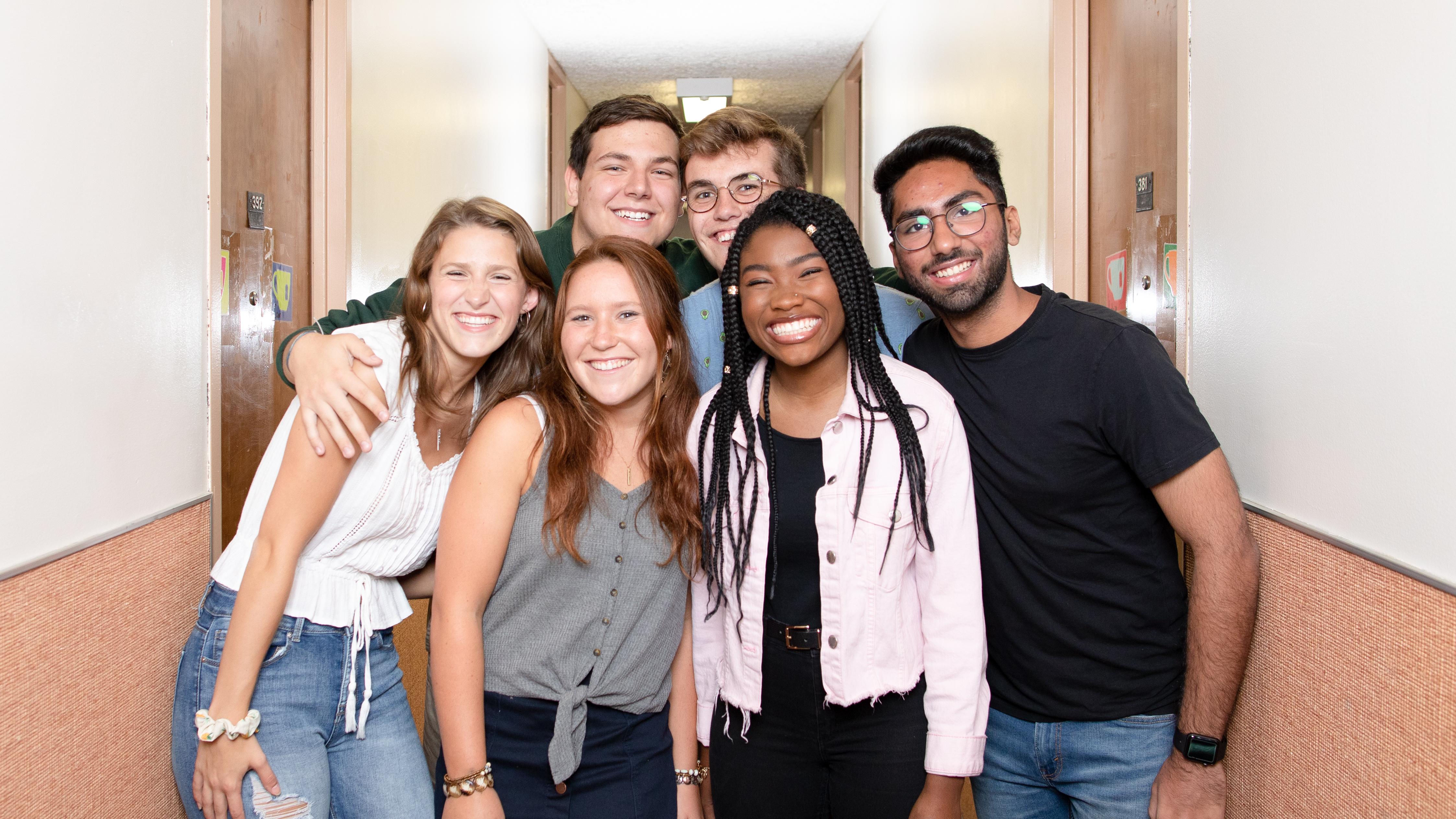 students gathered in the hallway of a residence wing