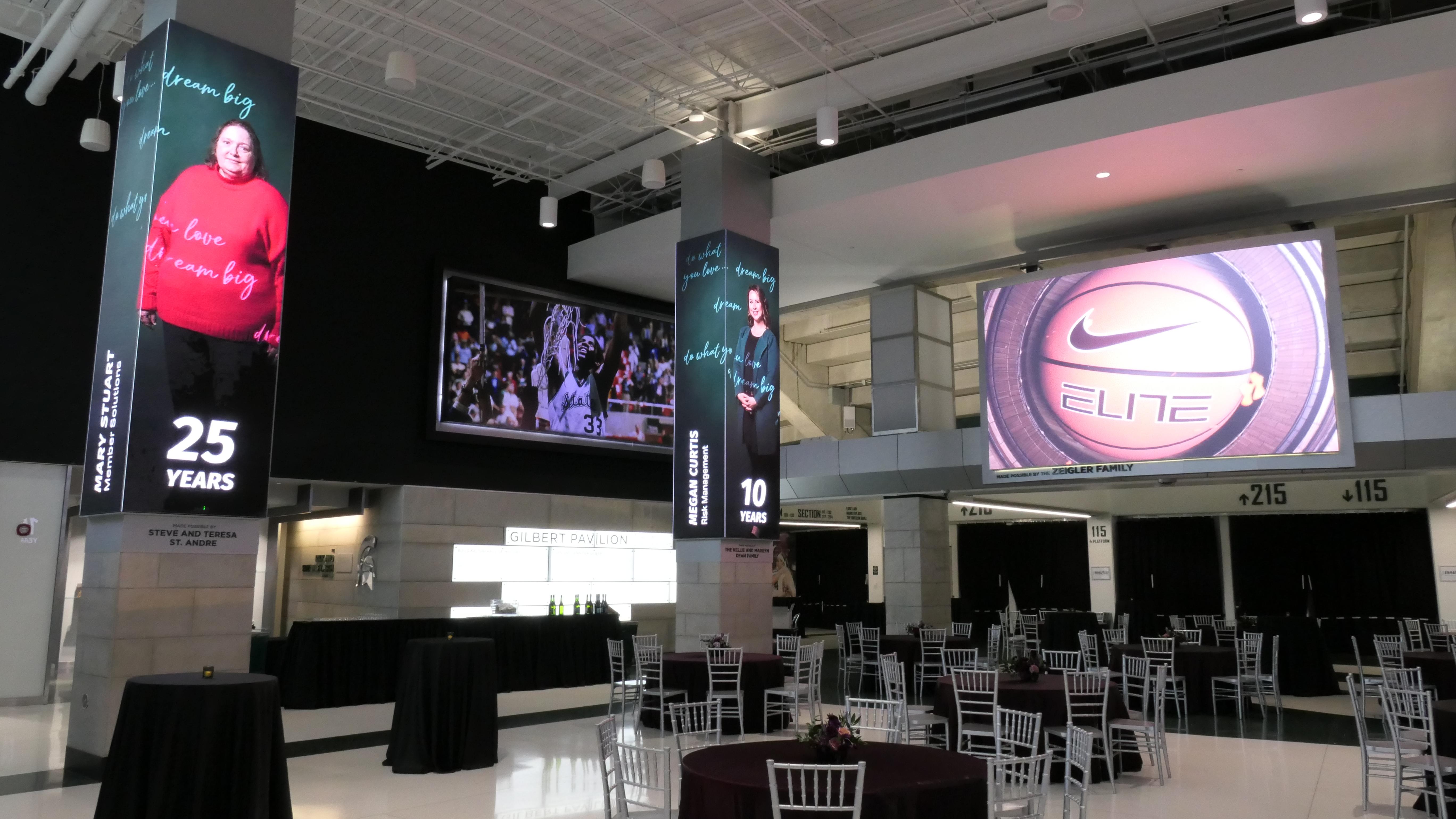 A view of the Breslin Center concourse with tables decorated with linens and flowers prior to the recent MSUFCU Banquet.