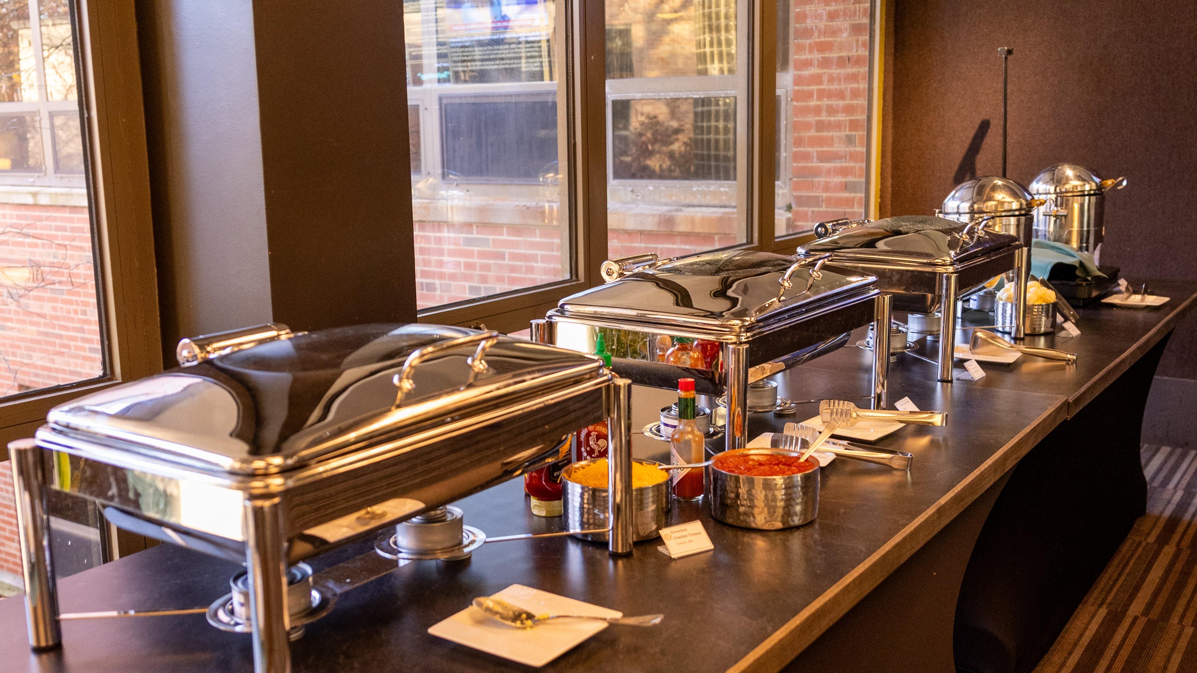Several food warming stations wait for hungry diners to dig in at the State Room buffet at the Kellogg Center.
